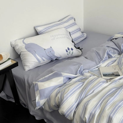 Angled shot of the Cat & Stripe Washed Cotton Bedding Set, highlighting the soft texture and the cute cat pillow. - RoomDen