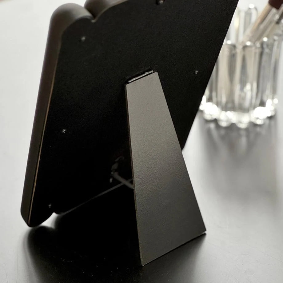 Detail of the black mirror's easel-style back stand. - RoomDen