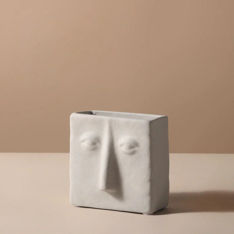 Front view of the small square abstract face vase with closed eyes - RoomDen.