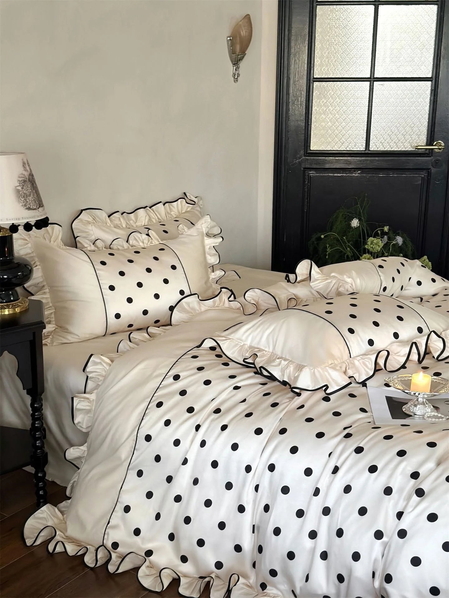 Close-up on the ruffled pillow shams of the Creamy White & Black Polka Dot Tencel Bedding Set - RoomDen.