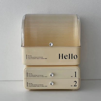 Direct front-on shot of the stacked cream ABS makeup organizer against a white wall.