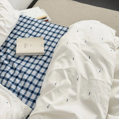 Top-down view showing the contrast between the blue gingham sheet and the white seagull duvet cover - RoomDen