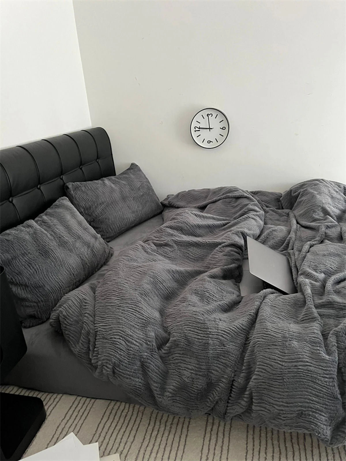A cozy corner with the Charcoal Grey ruched bedding set, perfect for relaxing and unwinding. - RoomDen