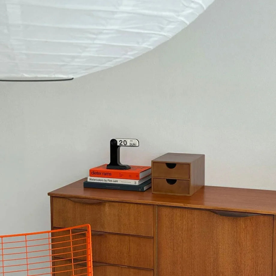 A shot from below looking up at the wooden desk organizer under a paper lantern, highlighting its clean form. - RoomDen