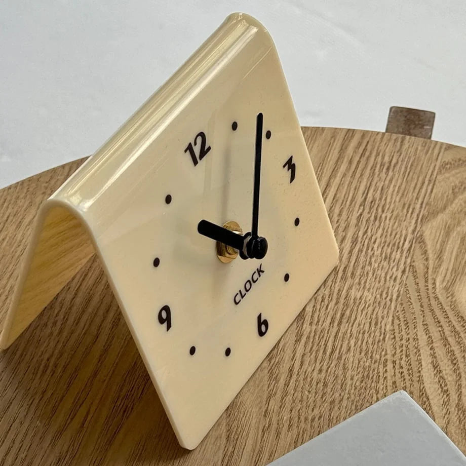 Close-up on the cream beige clock face with black hands. - RoomDen