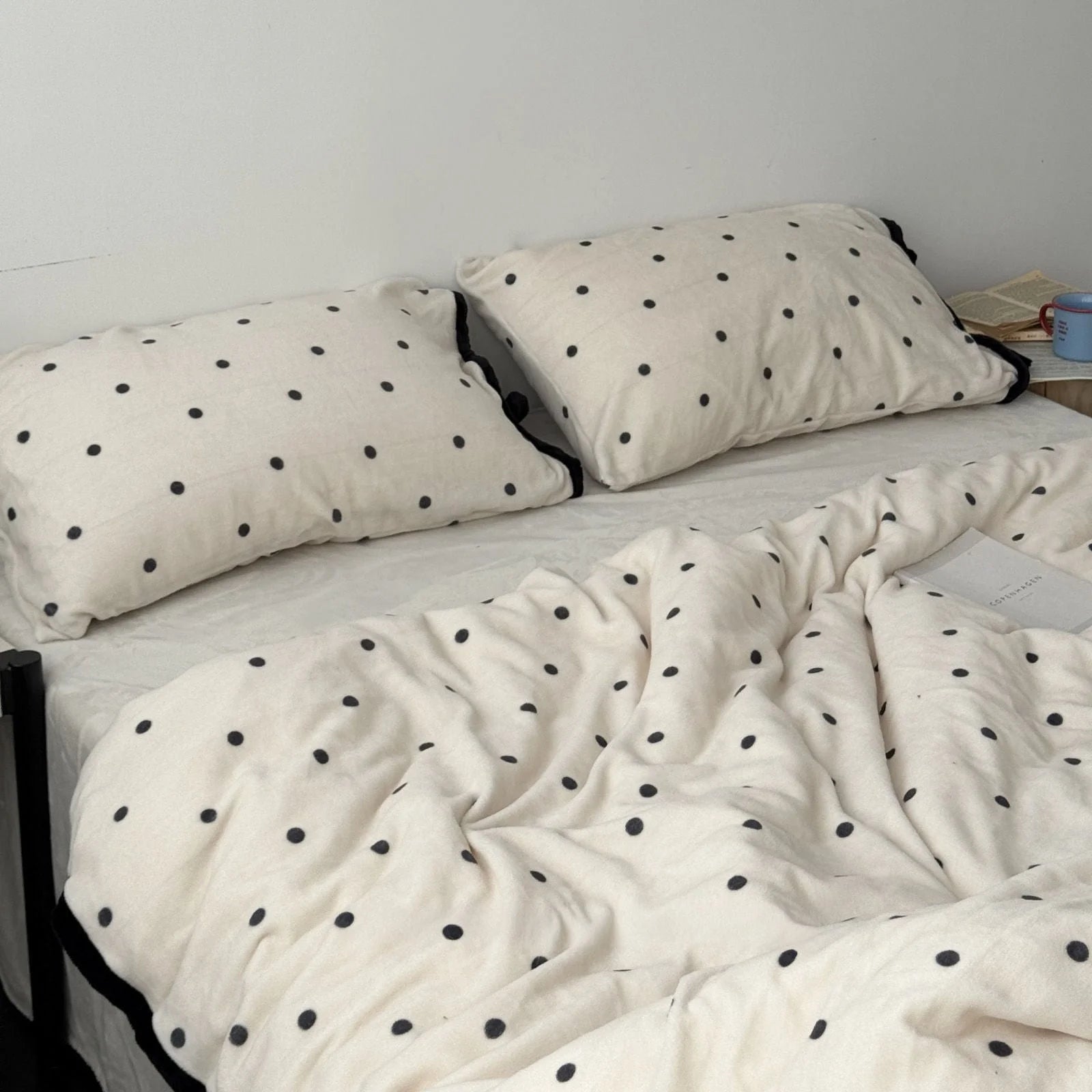 Full view of the Creamy White Polka Dot Flannel Fleece Bedding Set on a bed in a minimalist room - RoomDen.
