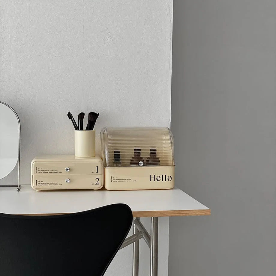 The two parts of the stackable makeup organizer placed side-by-side on a white vanity desk.