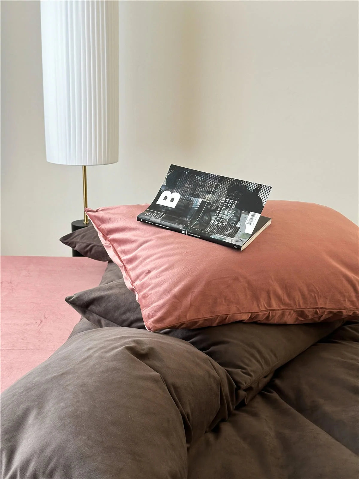 Detail shot of a dusty pink velvet pillow resting on a Mocha Brown velvet duvet cover. - RoomDen