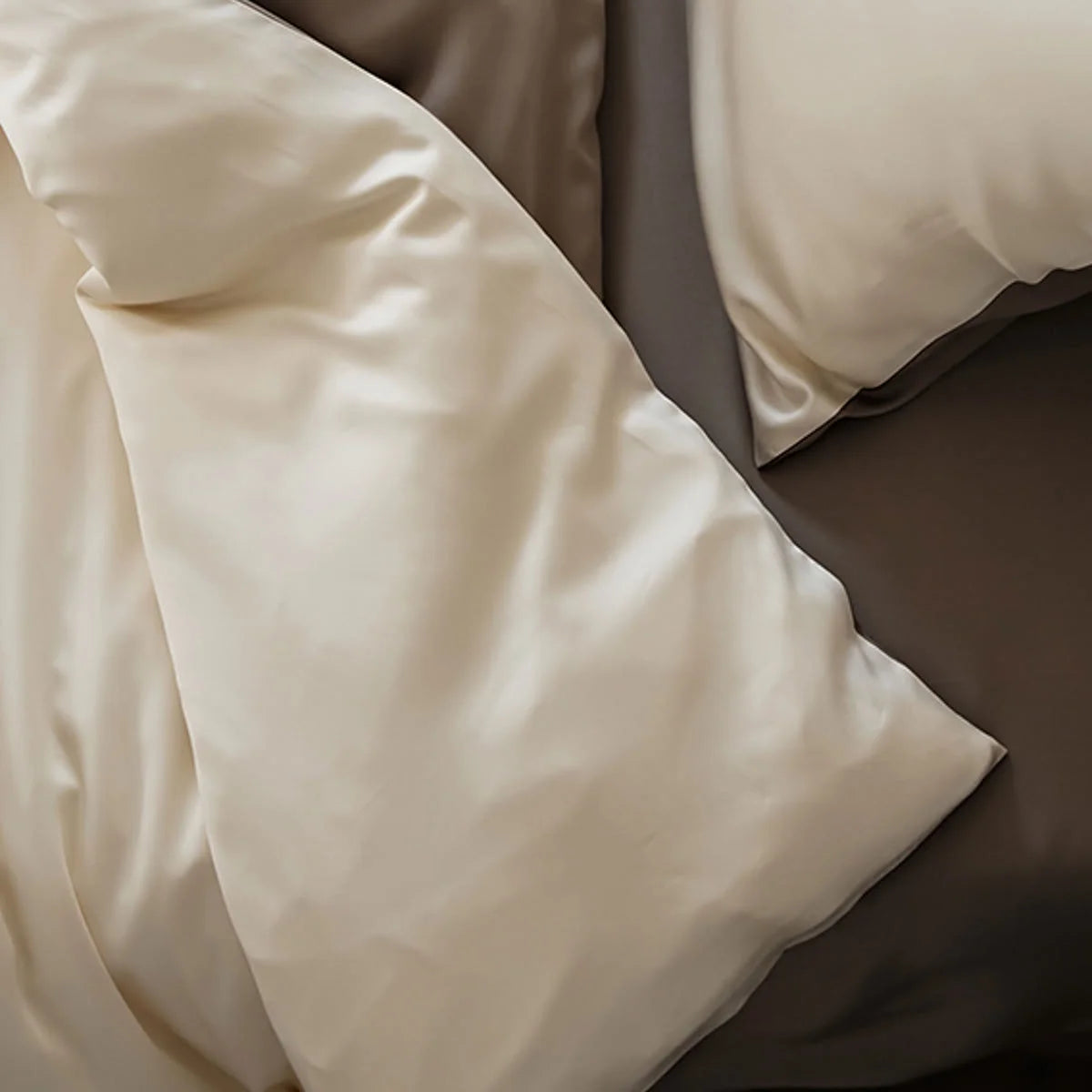 Corner of the Cream & Taupe Tencel duvet cover, highlighting the silky finish.