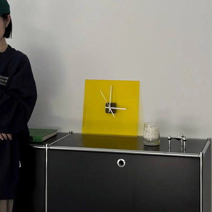 Zesty Yellow acrylic clock on a black cabinet with a person in a green cap standing nearby. - RoomDen