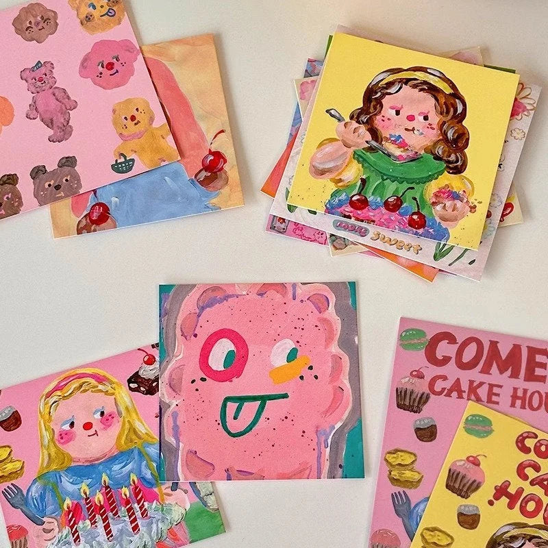 Close-up of several playful kawaii doodle art prints from the wall collage kit, featuring bears, cakes, and characters.