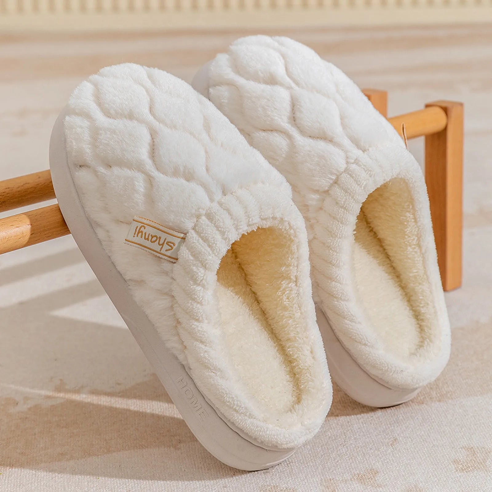 Pair of Cream White quilted cotton slippers on a wooden rack - RoomDen