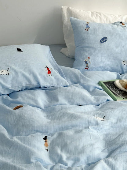 Sky blue version of the whimsical embroidered washed cotton bedding set, showing the duvet cover and pillowcases. - RoomDen