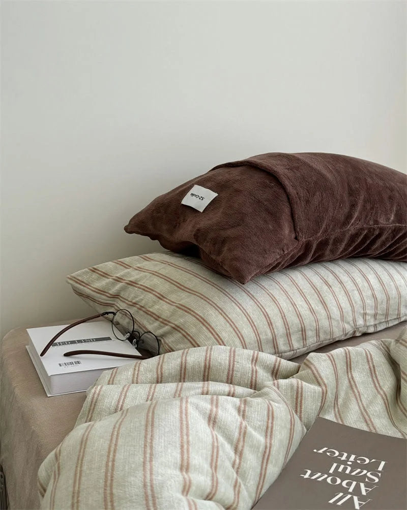 Beige Striped Plush Duvet Cover with Brown Pillow and Glasses