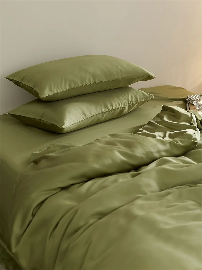 Close-up on the stacked pillows of the olive green Cooling Tencel bedding set, showing the fabric's soft folds - RoomDen.