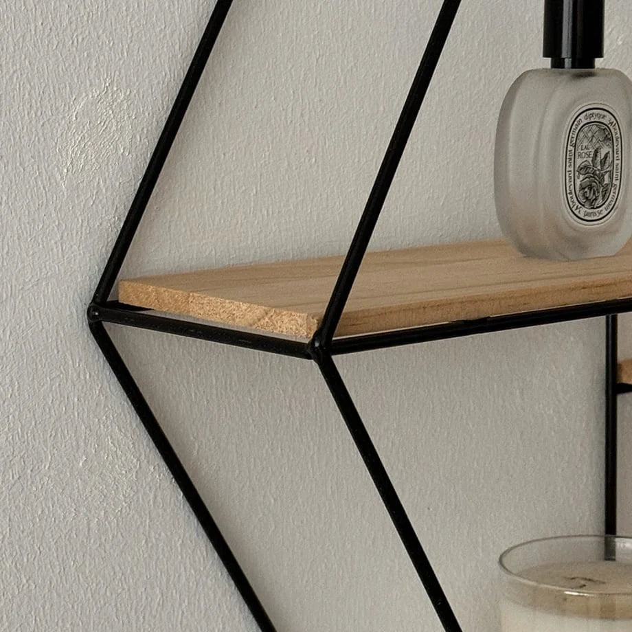 Detail shot of the corner joint on the black metal frame of the Hexagon Wall Shelf - RoomDen