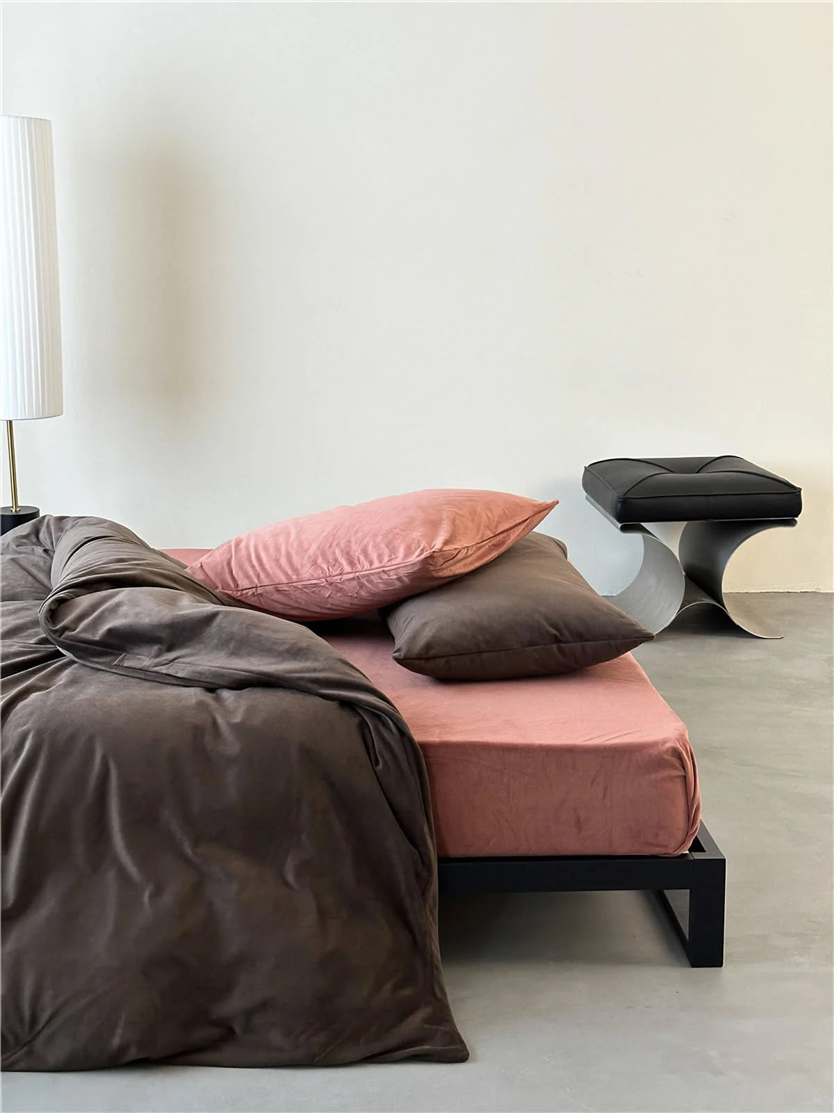 Side view of a bed with the Mocha Brown & Dusty Pink velvet bedding set in a minimalist room. - RoomDen