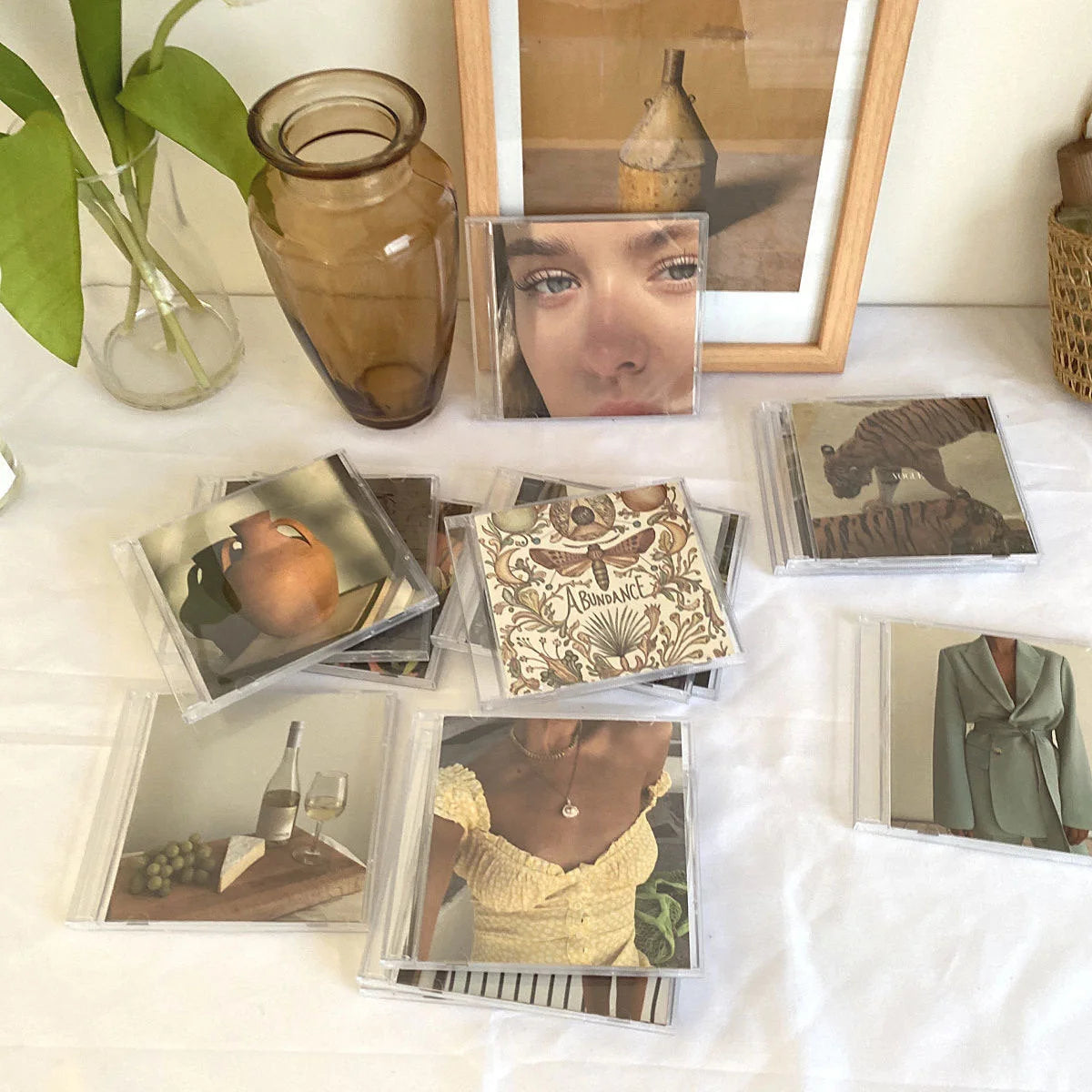 Aesthetic prints from the Wall Collage Kit displayed creatively inside clear CD jewel cases - RoomDen