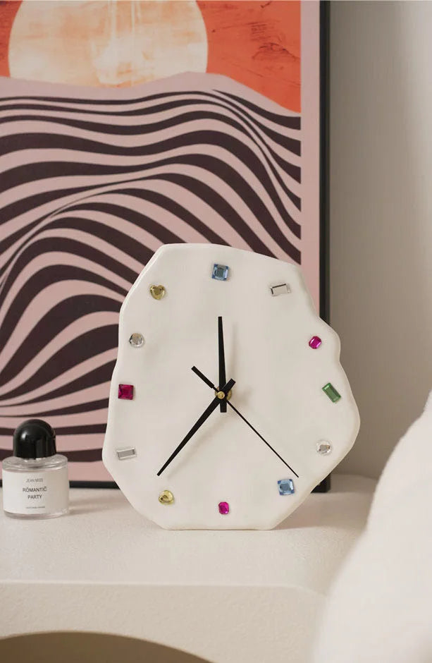White Wavy Jeweled Ceramic Clock on a nightstand in front of a modern art print - RoomDen