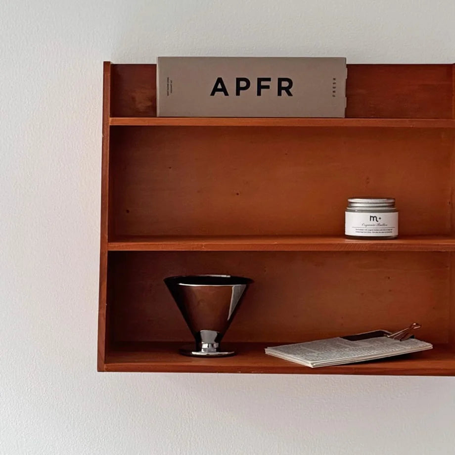 Close-up of the items displayed on the two-tier Slanted Wood Wall Shelf - RoomDen