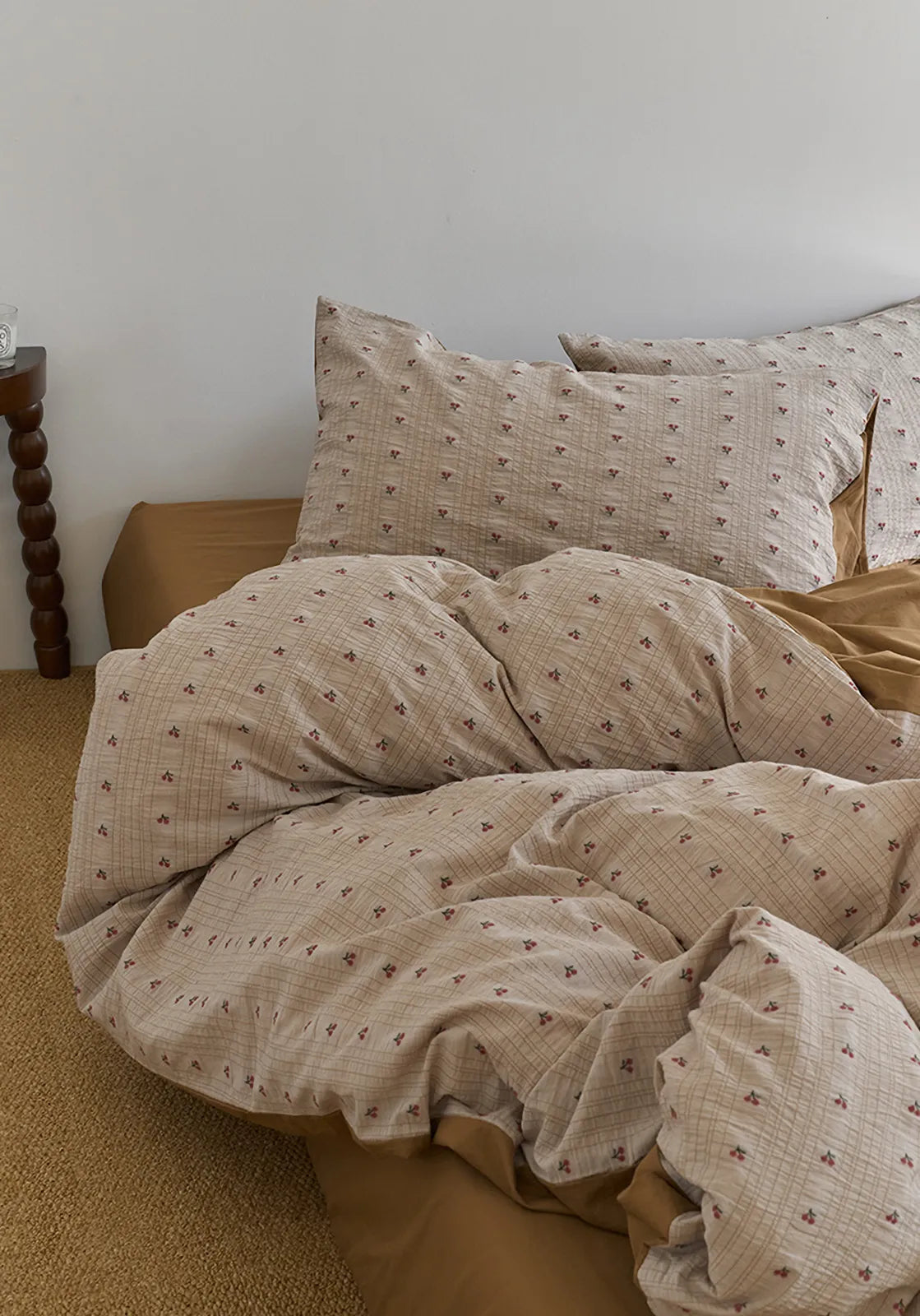 Angled shot of the Ditsy Cherry Washed Cotton Bedding Set, focusing on the texture of the duvet cover and pillows - RoomDen.