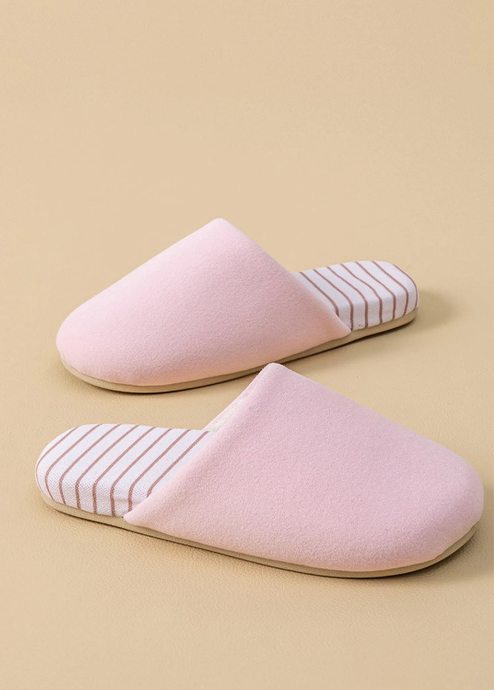 Side view of pink plush cotton house slipper showing soft texture and striped insole detail