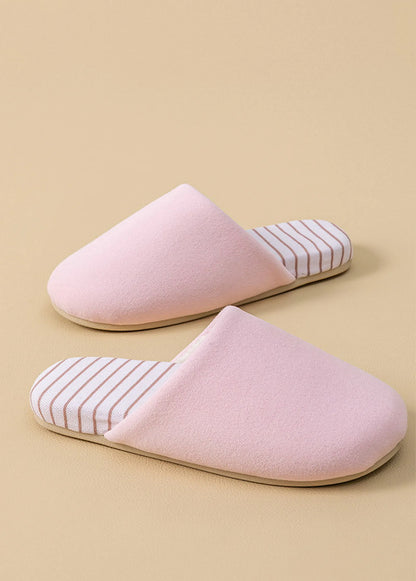 Side view of pink plush cotton house slipper showing soft texture and striped insole detail