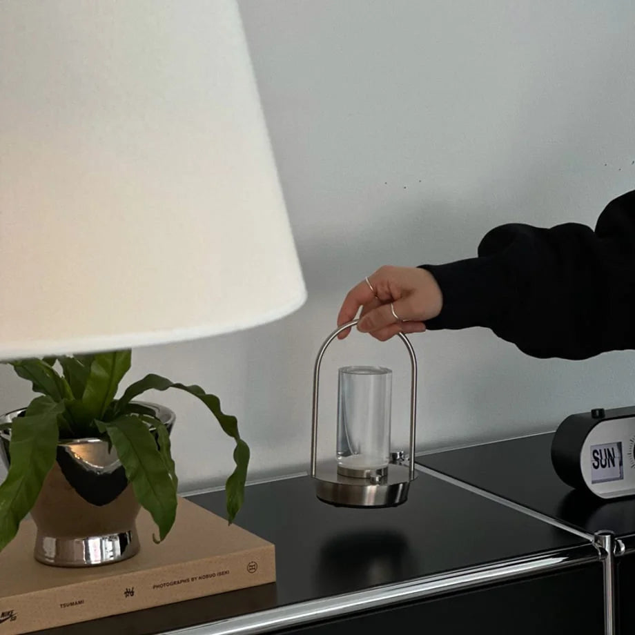 Detailed view of the portable accent lamp being held over a modern cabinet. - RoomDen