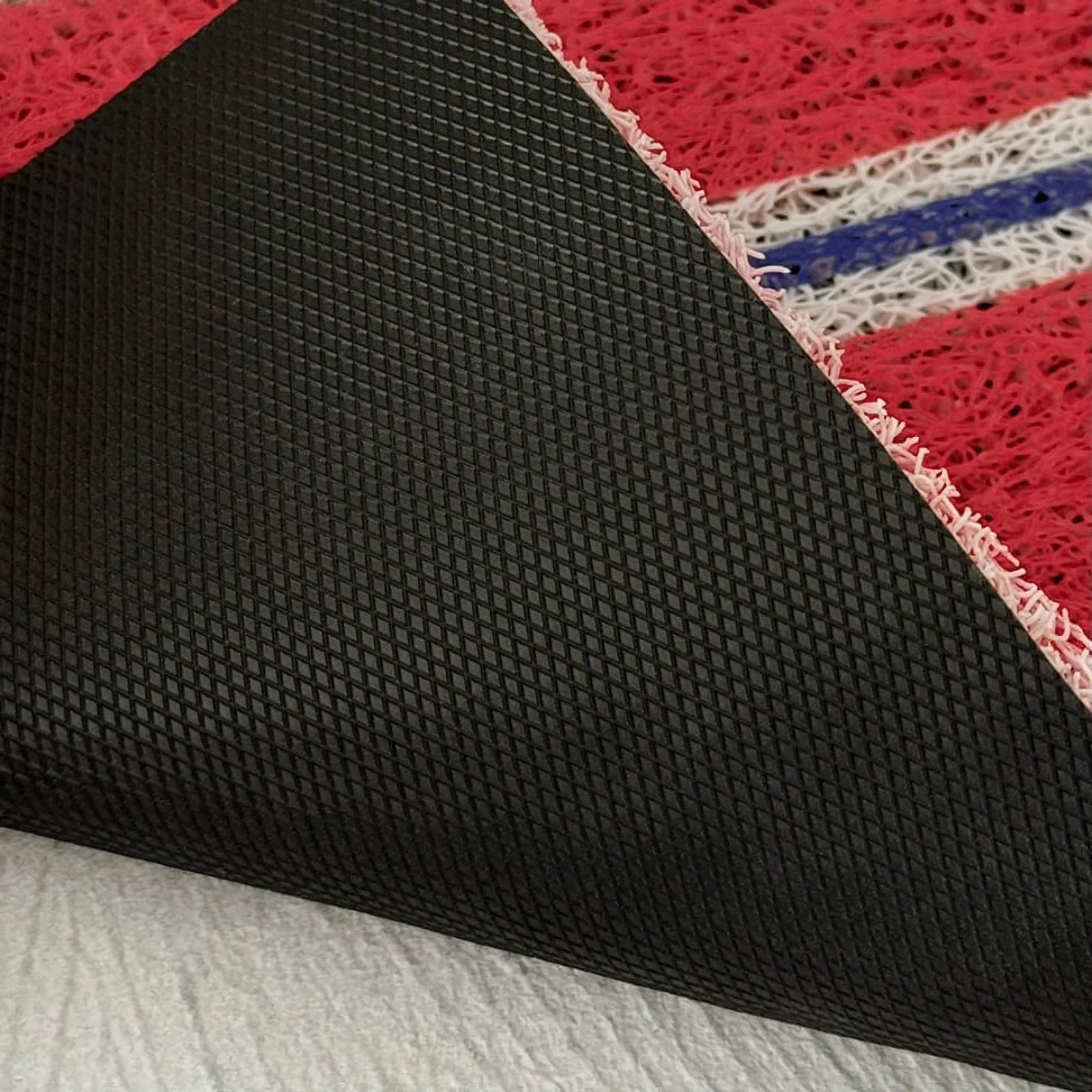 Non-slip black backing detail of PVC coil mat - RoomDen
