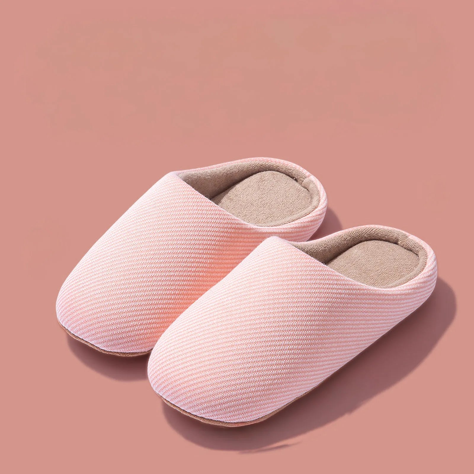 Pair of pink ribbed cotton house slippers isolated roomden