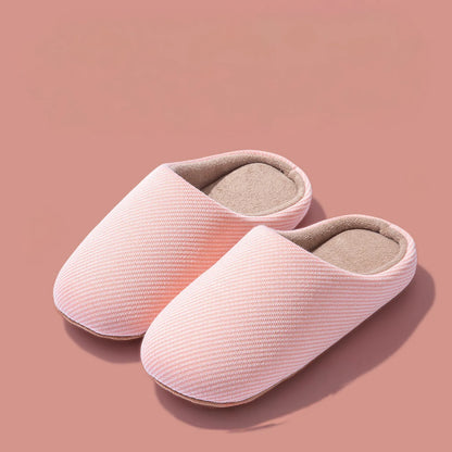 Pair of pink ribbed cotton house slippers isolated roomden