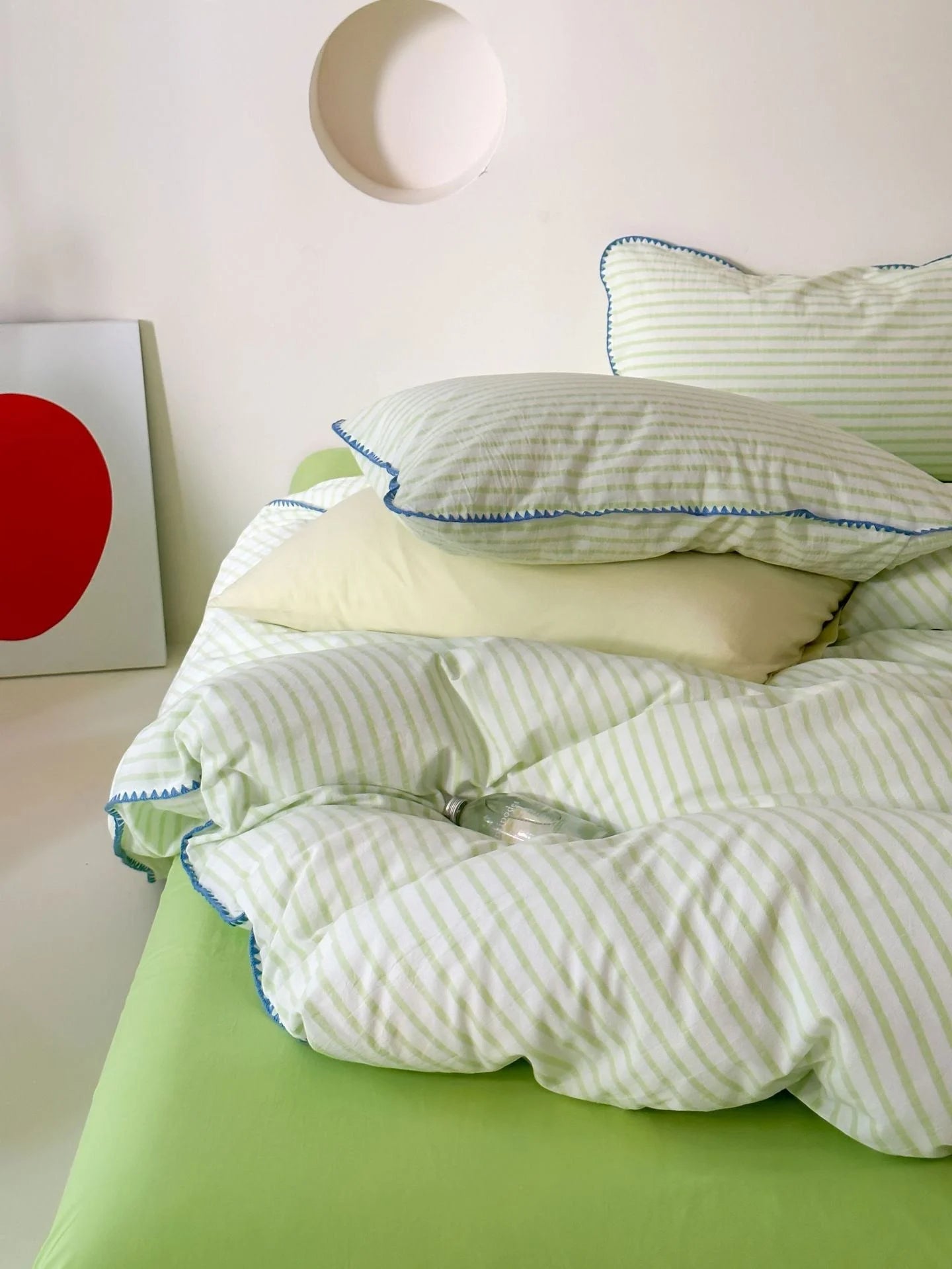 Close up of Green Striped Pillow and Blue Edge Detail - RoomDen
