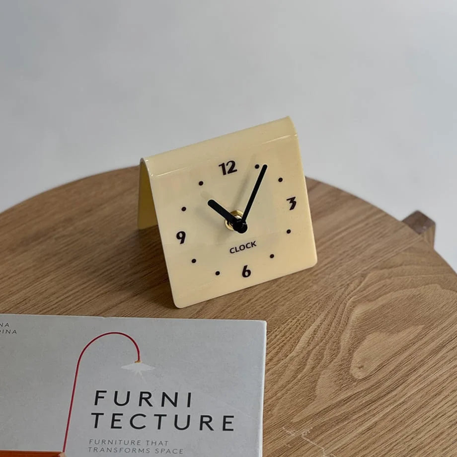 Angled view of the cream beige table clock showcasing its simple form. - RoomDen