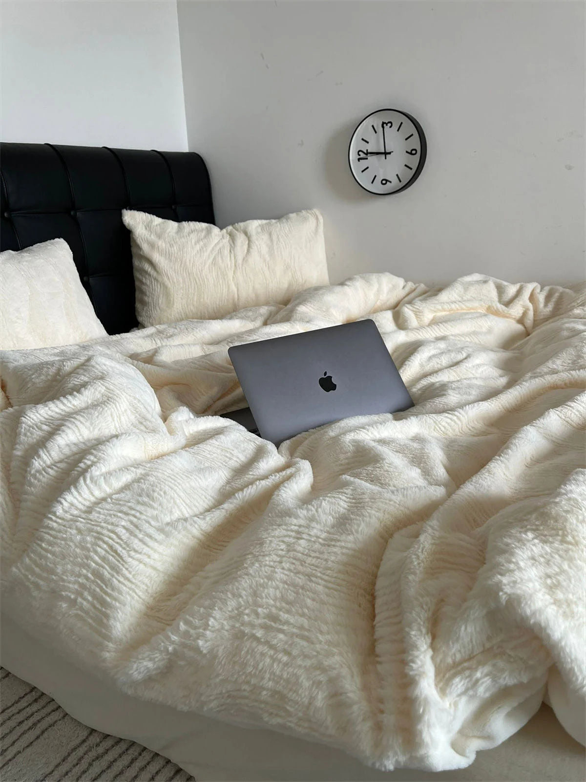 Close-up of the laptop on the incredibly soft and plush Creamy White fleece bedding set. - RoomDen