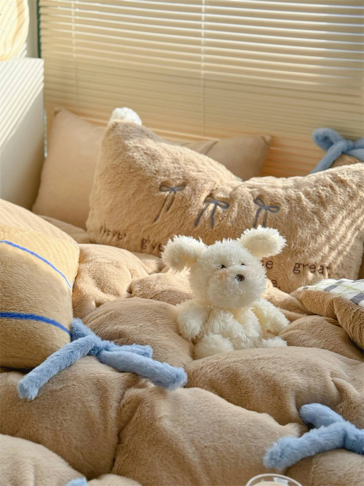 A cute white plush toy sitting on the Khaki Brown Bear bedding set. - RoomDen