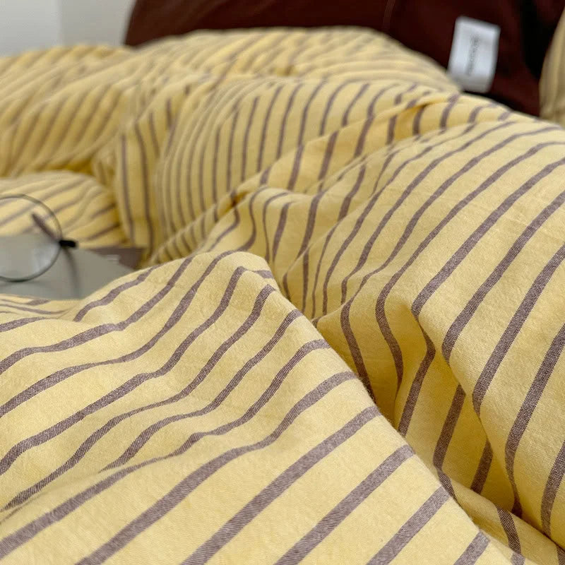 Macro shot of the Yellow & Brown pinstripe pattern on the soft, crinkled washed cotton duvet cover - RoomDen.