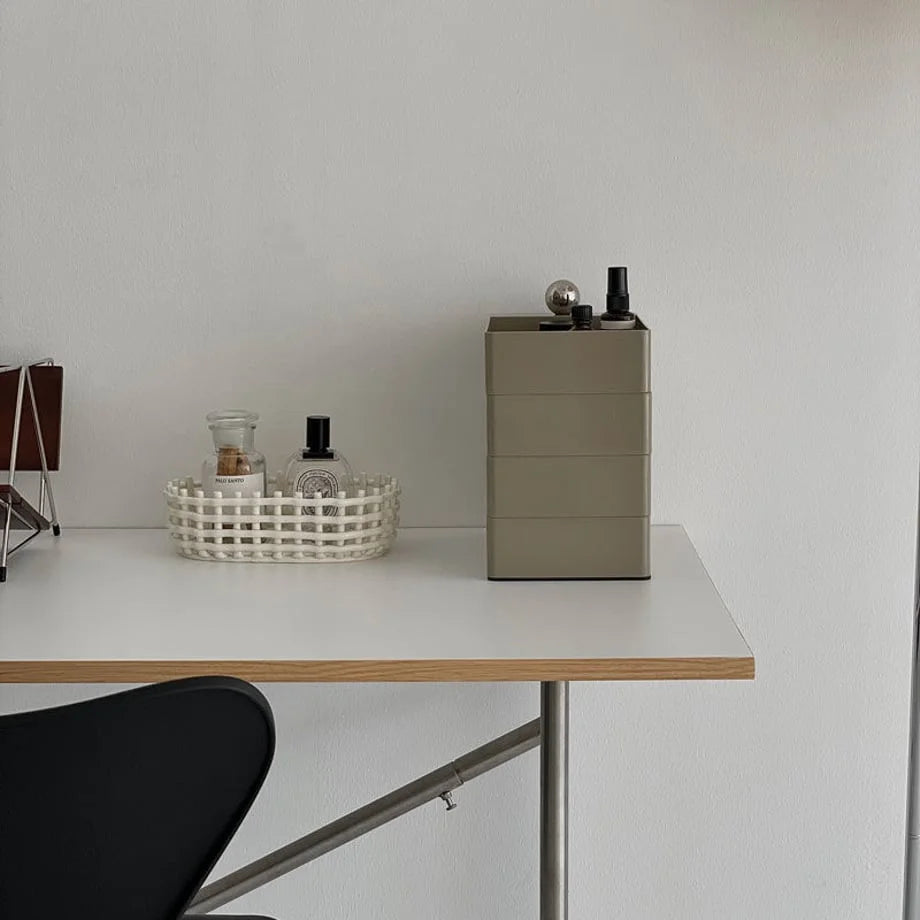 Sleek Minimalist ABS Rotating Makeup Organizer in Khaki Grey, styled on a modern white and wood desk.