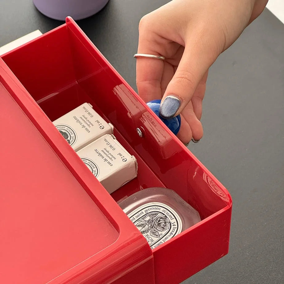 The red desk drawer opened to show small cosmetic items stored inside, highlighting its versatility. - RoomDen