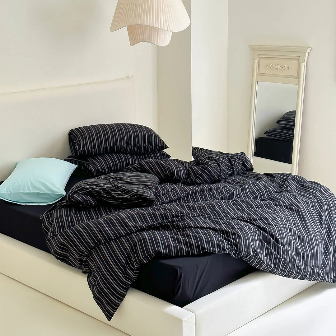 Full View of Black Striped Bedding in Minimalist White Room - RoomDen