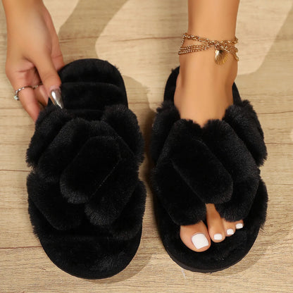 Pair of black faux fur open toe slides on floor - RoomDen