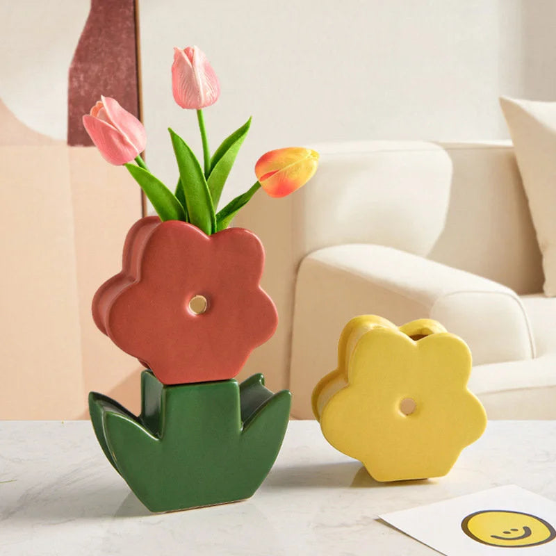 Daisy Bloom Ceramic Stacking Vase in Terracotta Red and Forest Green on a marble coffee table, with a yellow vase nearby. - RoomDen