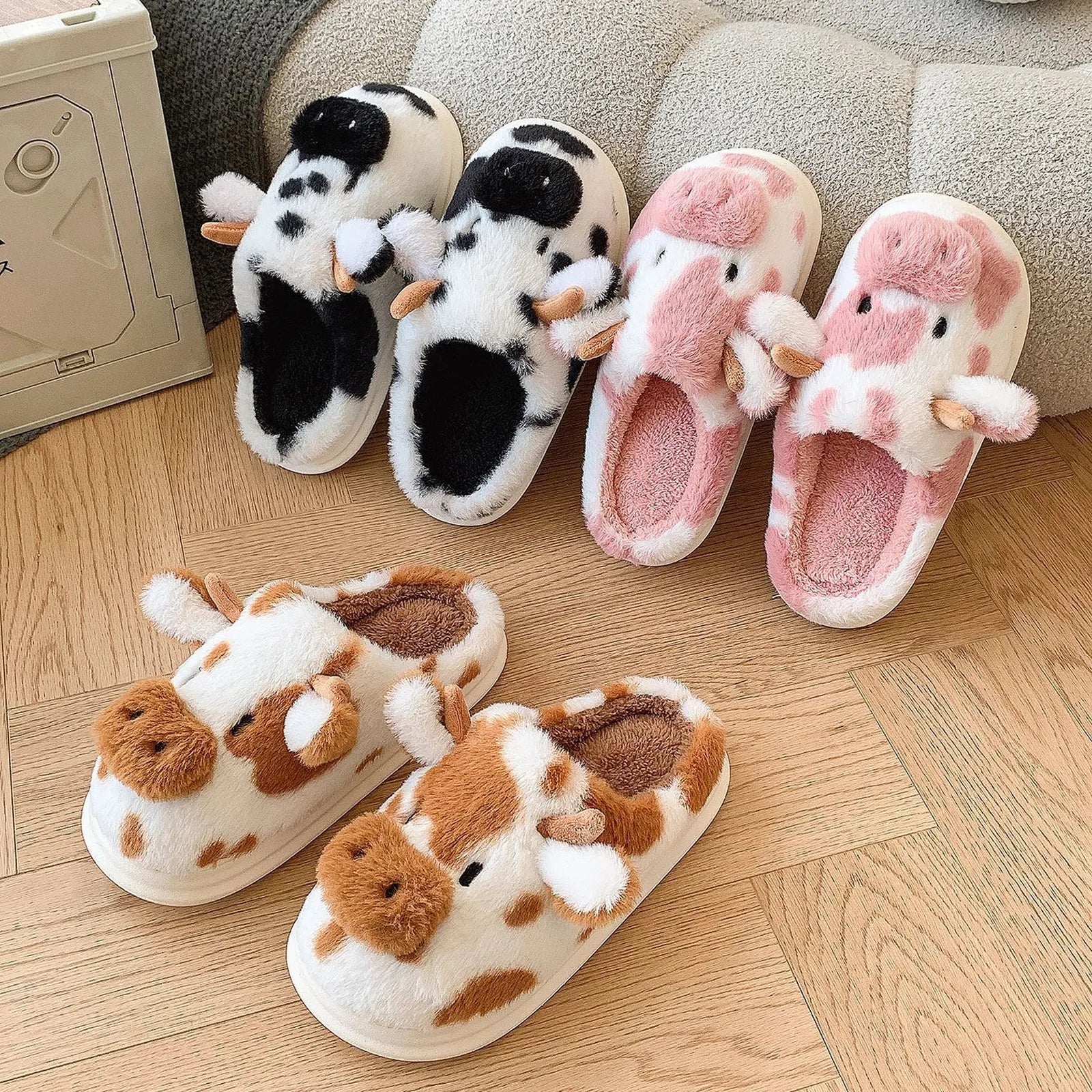 RoomDen Fuzzy Cow Print Plush House Slippers group shot showing Black, Brown, and Pink colorways.