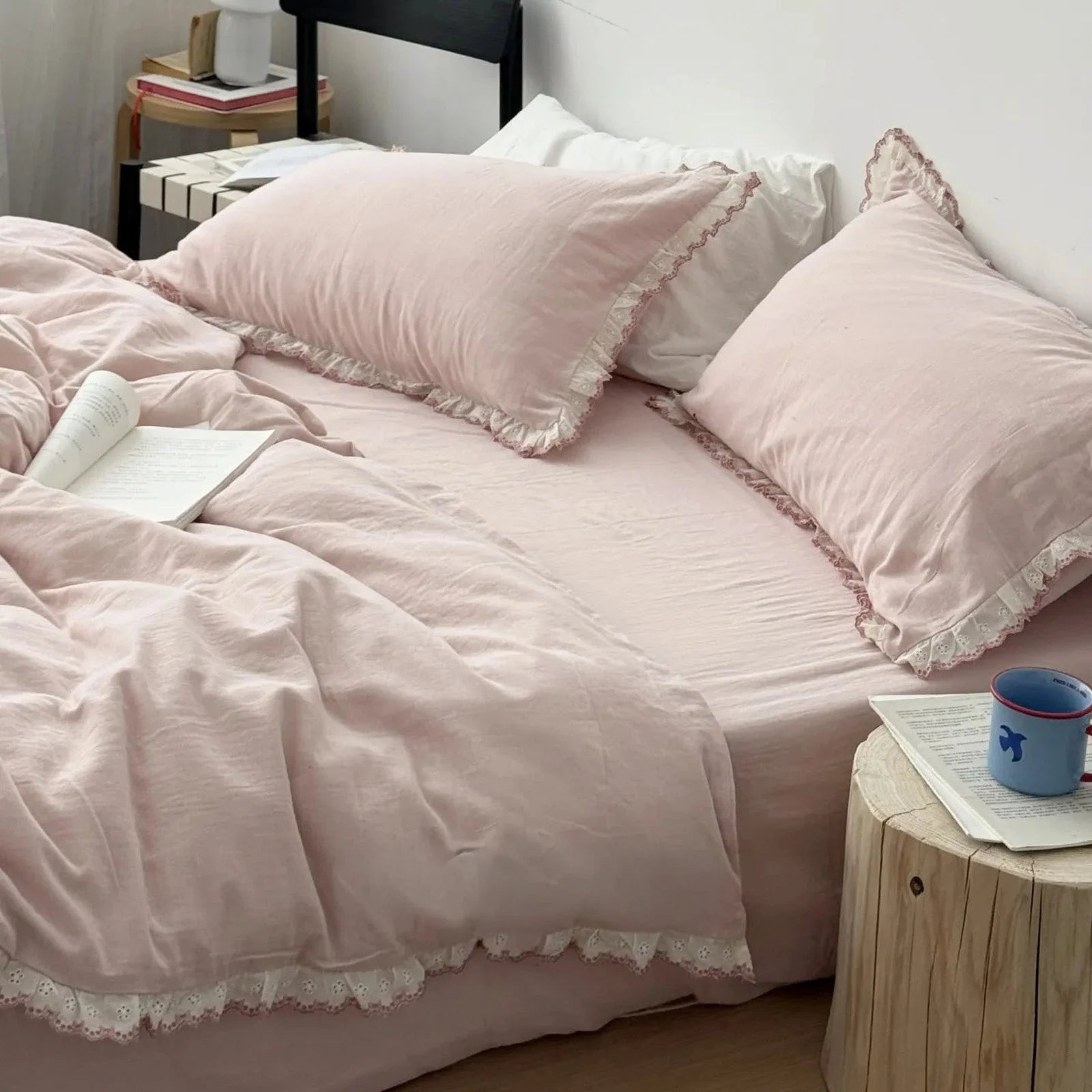 The dusty rose bedding set in a styled bedroom with a wooden side table, showing its Coquette aesthetic.