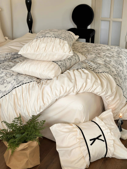 A cozy, tucked-in view of the Cream Toile bedding, emphasizing the soft texture of the washed cotton. - RoomDen