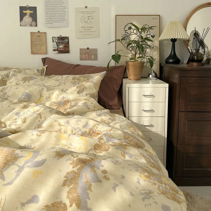 Lifestyle image of the Buttercream Floral bedding set creating a warm, sun-drenched vibe in an artistic bedroom. - RoomDen