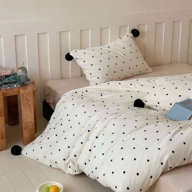 The Cream White Polka Dot Pom Pom Velvet Bedding Set variant displayed in a brightly lit bedroom. - RoomDen