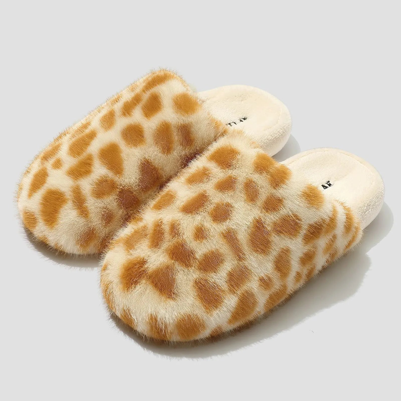 Isolated pair of Beige & Brown Spots giraffe print plush slippers