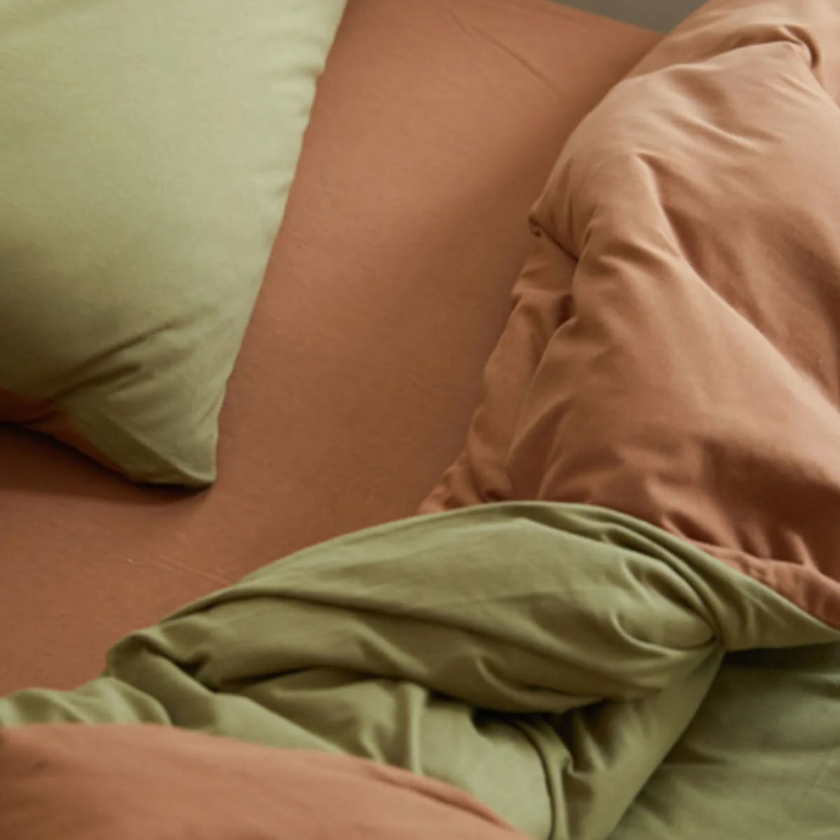 Top Down View of Reversible Olive and Cinnamon Bedding Layers - RoomDen