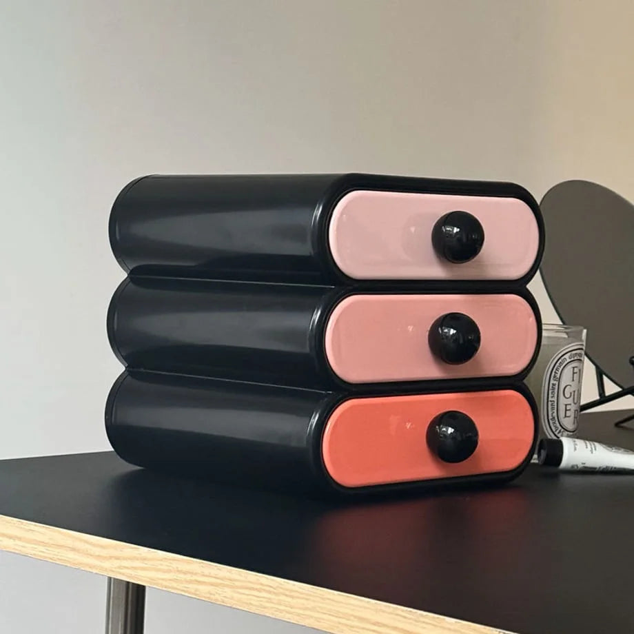 Side profile of the glossy black wavy makeup organizer, highlighting its curved silhouette. - RoomDen
