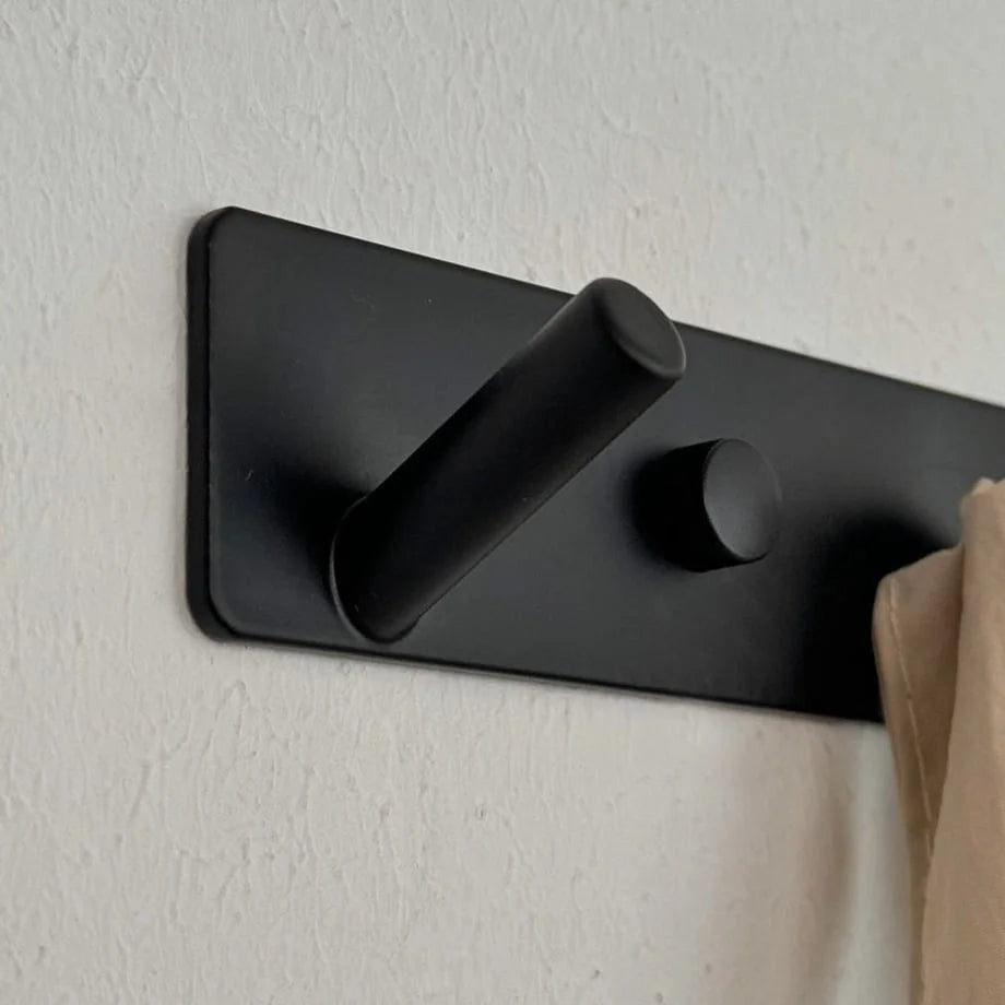 Angled view of a single peg on the minimalist black metal wall hook rack - RoomDen.